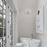 A sculptural freestanding tub sits beside the French bathroom, bathroom accessory, floor, home, interior design, plumbing fixture, product design, room, sink, tap, gray