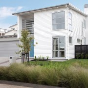 Cladding features painted timber weatherboards, and there are building, cottage, elevation, estate, facade, home, house, neighbourhood, property, real estate, residential area, siding, suburb, white, brown