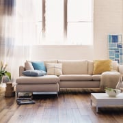 In modern commercial interiors, an eye-catching furnishing scheme angle, chair, coffee table, couch, floor, flooring, furniture, hardwood, home, interior design, laminate flooring, living room, loveseat, product design, room, sofa bed, table, wall, wood, wood flooring, white