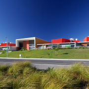 Hobsonville Point Primary School, built before the Hobsonville architecture, corporate headquarters, daytime, estate, home, house, metropolitan area, property, real estate, residential area, sky, suburb, blue, brown