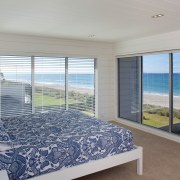 Master suite with a prime position and expansive bedroom, condominium, door, estate, home, interior design, property, real estate, room, window, window blind, window covering, window treatment, wood, gray