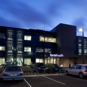 Advanced seismic damping ensures the Forté Health building apartment, architecture, building, car, city, commercial building, condominium, corporate headquarters, evening, facade, family car, home, house, luxury vehicle, metropolitan area, mixed use, neighbourhood, real estate, residential area, sky, blue, black