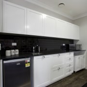 White limante kitchen with stainless steel appliances cabinetry, countertop, cuisine classique, interior design, kitchen, kitchen stove, room, gray, black