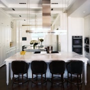 Black bar stools and a dark walnut floor cabinetry, countertop, cuisine classique, dining room, floor, flooring, interior design, kitchen, room, wood flooring, white, black