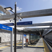 Railway stations through the region, including New Lynn, architecture, building, city, metropolitan area, road, sky, structure, transport, gray, teal