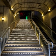 Unique Creative created this barrel-vault ceiling for a architecture, darkness, escalator, infrastructure, light, lighting, metro station, metropolitan area, night, public transport, rapid transit, stairs, subway, tunnel, brown