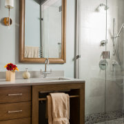 A oak-framed mirror matches the vanity cabinetry in bathroom, bathroom accessory, bathroom cabinet, interior design, plumbing fixture, room, sink, gray, brown