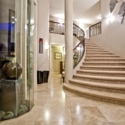 Grand, sweeping marble staircase and floor greets the apartment, estate, floor, flooring, home, interior design, lobby, property, real estate, stairs, gray, orange, brown