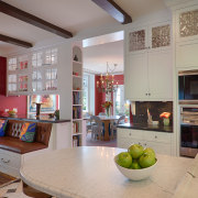 A double-sided glazed overhead cabinet forms a transparent ceiling, countertop, home, house, interior design, kitchen, living room, real estate, room, table, gray