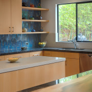 The kitchen features two parallel islands, one for cabinetry, countertop, daylighting, interior design, kitchen, room, table, window, wood, gray