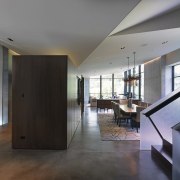 The inverted floating ceiling creates a modern aesthetic apartment, architecture, ceiling, condominium, daylighting, estate, floor, flooring, hardwood, house, interior design, living room, lobby, loft, property, real estate, room, stairs, window, wood, wood flooring, gray, black