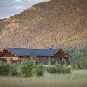 This rustic-looking mountain home by architect Stephen Dynia biome, cloud, cottage, farm, field, grassland, highland, hill, home, house, hut, landscape, log cabin, morning, mountain, mountain range, mountainous landforms, national park, nature, real estate, roof, rural area, sky, sunlight, tree, wilderness, brown