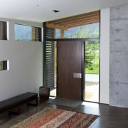 The entry to this mountain home  by architecture, ceiling, door, floor, house, interior design, wall, gray
