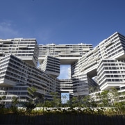 With its stacked blocks arranged in a hexagonal apartment, architecture, building, commercial building, condominium, corporate headquarters, daytime, facade, headquarters, landmark, metropolis, metropolitan area, mixed use, property, real estate, residential area, sky, tower block, blue, black