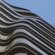 The undulating form of the aluminium-clad balconies on angle, architecture, building, daytime, facade, landmark, line, roof, sky, structure, black, teal