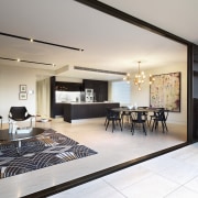 This open-plan living area includes the apartment's kitchen, apartment, ceiling, house, interior design, living room, penthouse apartment, property, real estate, room, gray