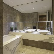 This marble-clad master bathroom has double vanities and architecture, bathroom, estate, interior design, property, room, brown