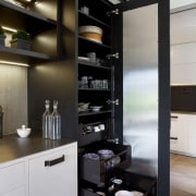 Storage is provided in tall cabinets either side furniture, interior design, kitchen, black, gray