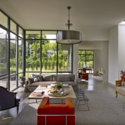 The central living area in this house is architecture, house, interior design, living room, real estate, window, gray