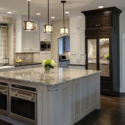 This kitchen design provides ample storage, including two cabinetry, countertop, cuisine classique, floor, flooring, hardwood, interior design, kitchen, room, wood flooring, gray, black