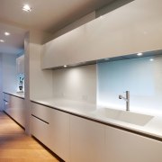 White gloss Boffi cabinets appear to float in architecture, cabinetry, ceiling, countertop, daylighting, floor, glass, home, interior design, kitchen, light fixture, lighting, real estate, room, under cabinet lighting, wall, gray