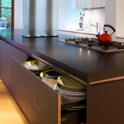 Glass-fronted doors and drawers on the island feature cabinetry, countertop, interior design, kitchen, brown