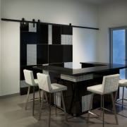 Sliding doors conceal part of this glittering bar dining room, furniture, interior design, room, table, gray, black