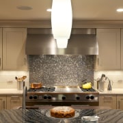 The new kitchen features an exotic granite island countertop, flooring, interior design, kitchen, light fixture, room, under cabinet lighting, brown