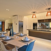 The kitchen island in this Jalcon Homes show ceiling, estate, interior design, living room, property, real estate, orange, brown