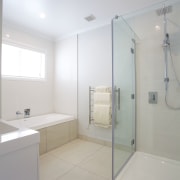 Sleek, contemporary bathrooms feature throughout this show home architecture, bathroom, ceiling, daylighting, floor, home, interior design, plumbing fixture, product design, property, real estate, room, tile, gray, white