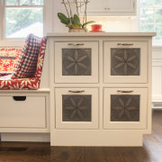 A small peninsula beside a banquette seating area cabinetry, chest of drawers, drawer, floor, flooring, furniture, hardwood, wood stain, white, brown