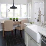 Casual dining space in small traditional kitchen with bathroom, countertop, floor, flooring, home, interior design, kitchen, product design, room, sink, tap, tile, white