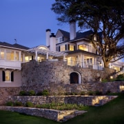 Stonework on this home continues onto the newly architecture, building, cottage, estate, evening, facade, historic house, home, house, landscape lighting, lighting, mansion, property, real estate, residential area, sky, villa, black