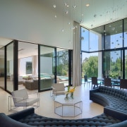 The entry leads directly into a large, double-height apartment, architecture, ceiling, condominium, daylighting, estate, house, interior design, living room, lobby, real estate, window, gray