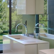 Wading basins are integrated into the vanities on bathroom, bathroom accessory, bathroom cabinet, countertop, interior design, kitchen, sink, gray