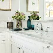 White lacquered cabinets are teamed with Carrara marble bathroom, bathroom accessory, bathroom cabinet, cabinetry, countertop, home, interior design, kitchen, product design, room, sink, tap, white