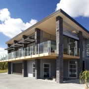 This holiday home features a custom design by architecture, building, elevation, estate, facade, home, house, mixed use, property, real estate, residential area, villa, white