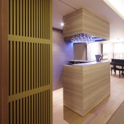 Limestone-clad bar in contemporary waterfront apartment architecture, cabinetry, ceiling, floor, flooring, furniture, interior design, wood, brown