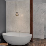 A mosaic blade wall hides the toilet and bathroom, bathroom sink, bidet, ceramic, floor, flooring, interior design, plumbing fixture, product design, room, sink, tap, tile, wall, gray