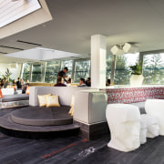 This seaside entertainment venue features a covered outdoor furniture, interior design, lobby, white, gray