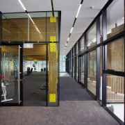 Sliding doors open out to a deck on architecture, building, door, glass, lobby, metropolitan area, real estate, window, gray, black