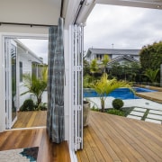 Smooth-running bifolds from Fairview Systems open up these backyard, balcony, daylighting, deck, house, interior design, property, real estate, window, gray