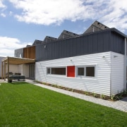 The photovoltaic cells on the roof of this cottage, facade, home, house, property, real estate, shed, siding, white