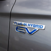 The Mitsubishi Outlander Plug-In Hybrid SUV is powered automotive design, automotive exterior, automotive lighting, blue, car, family car, font, graphics, logo, mode of transport, motor vehicle, personal luxury car, vehicle, vehicle door, gray, black