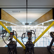 Glazed walls allow a view of the pool architecture, gym, sport venue, structure, gray