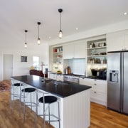 This traditionally styled kitchen, designed and manufactured by countertop, floor, flooring, hardwood, interior design, kitchen, room, wood flooring, gray