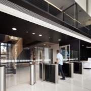 A black ceiling creates an intimate entry for glass, interior design, lobby, black, white