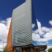 Designed by MAP Architects, this new building, at architecture, building, commercial building, condominium, corporate headquarters, daytime, facade, headquarters, house, mixed use, sky, tower block, blue