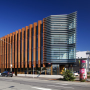 Corten steel fins define the northwest exterior of apartment, architecture, building, city, commercial building, condominium, corporate headquarters, downtown, facade, headquarters, metropolis, metropolitan area, mixed use, neighbourhood, real estate, residential area, sky, tower block, urban area, blue