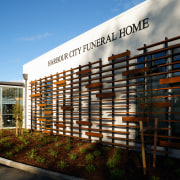 The cedar screen on this new funeral home architecture, building, condominium, corporate headquarters, facade, mixed use, real estate, residential area, sky, black